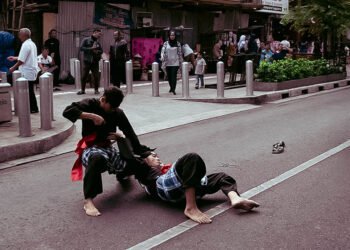 Pencak silat practitioners demonstrate traditional martial arts techniques representing the history of pencak silat from Nusantara heritage to global competition.