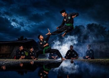 Pencak silat practitioners demonstrating traditional martial arts movements that reflect the regional histories behind the terms pencak and silat.