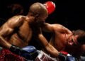 Chris John fights Simpiwe Vetyeka during their 2013 featherweight title bout in Perth.