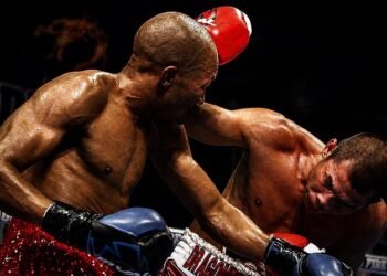 Chris John fights Simpiwe Vetyeka during their 2013 featherweight title bout in Perth.