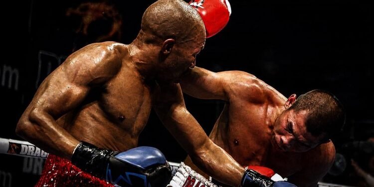 Chris John fights Simpiwe Vetyeka during their 2013 featherweight title bout in Perth.