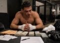Professional fighter receiving payment paperwork after a combat sports bout