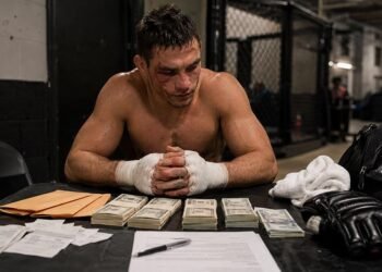 Professional fighter receiving payment paperwork after a combat sports bout