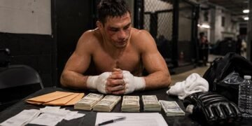 Professional fighter receiving payment paperwork after a combat sports bout